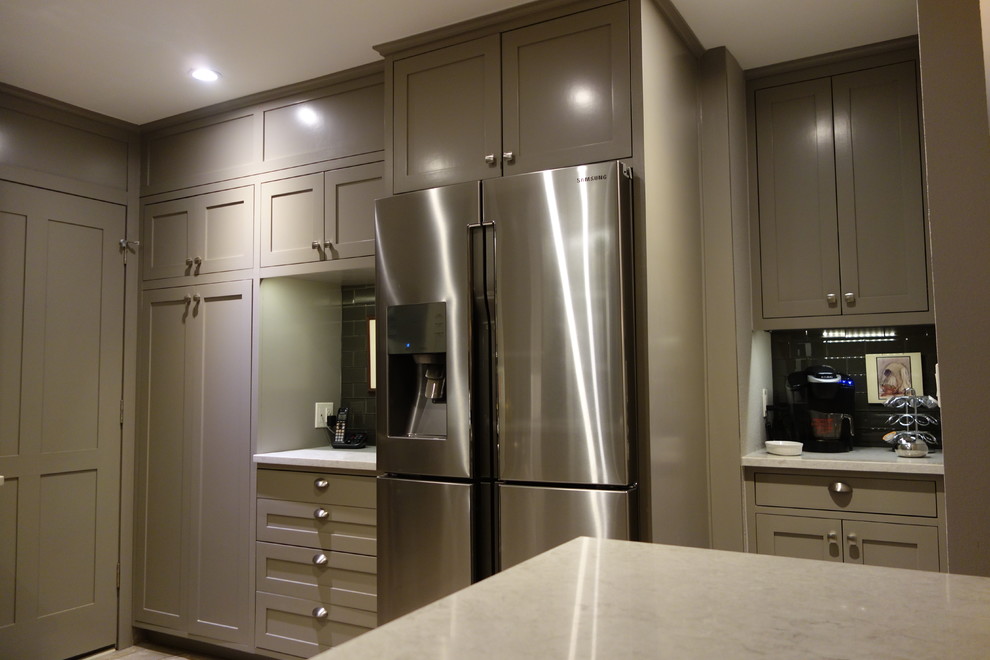 Inspiration for a small transitional u-shaped ceramic tile home design remodel with an undermount sink, shaker cabinets, gray cabinets, quartz countertops, gray backsplash, glass tile backsplash, stainless steel appliances and a peninsula