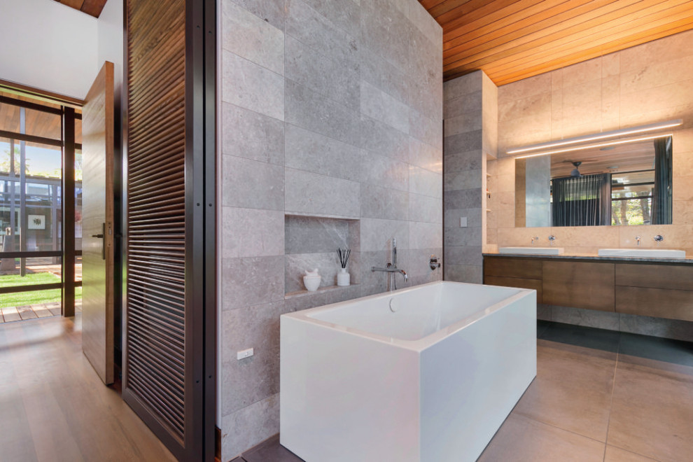 Inspiration for a mid-sized asian master gray tile and stone slab double-sink freestanding bathtub remodel in Auckland with a built-in vanity