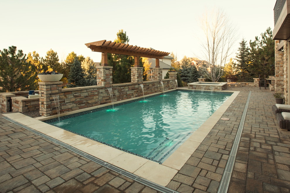 Inspiration for a mid-sized rustic backyard stone and rectangular pool remodel in Denver