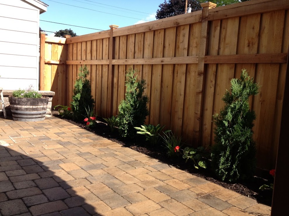 Patio - large traditional backyard brick patio idea in Minneapolis with no cover