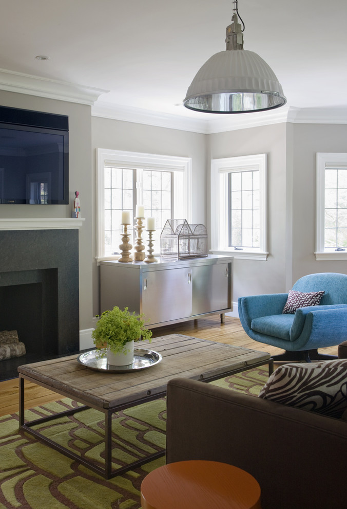 Design ideas for a traditional family room in Boston with grey walls, medium hardwood floors and a wall-mounted tv.
