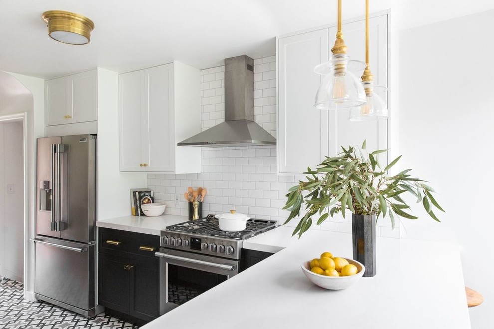 Inspiration for a mid-sized transitional l-shaped separate kitchen in Salt Lake City with a drop-in sink, white cabinets, white splashback, subway tile splashback, stainless steel appliances, cement tiles and multi-coloured floor.