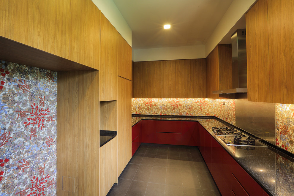Design ideas for a large modern u-shaped separate kitchen with a double-bowl sink, recessed-panel cabinets, medium wood cabinets, granite benchtops, red splashback, ceramic splashback, panelled appliances, ceramic floors, no island and grey floor.