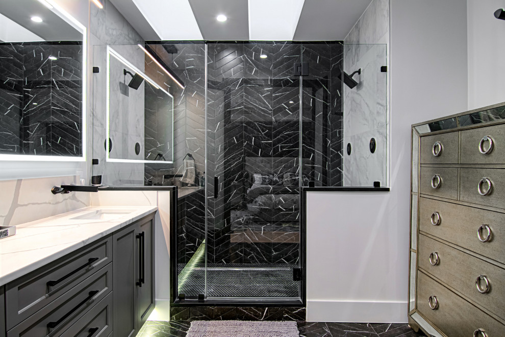 This is an example of a medium sized modern ensuite bathroom in Miami with shaker cabinets, grey cabinets, a double shower, a one-piece toilet, black tiles, porcelain tiles, white walls, porcelain flooring, a built-in sink, engineered stone worktops, black floors, a hinged door, white worktops, a shower bench, double sinks and a built in vanity unit.