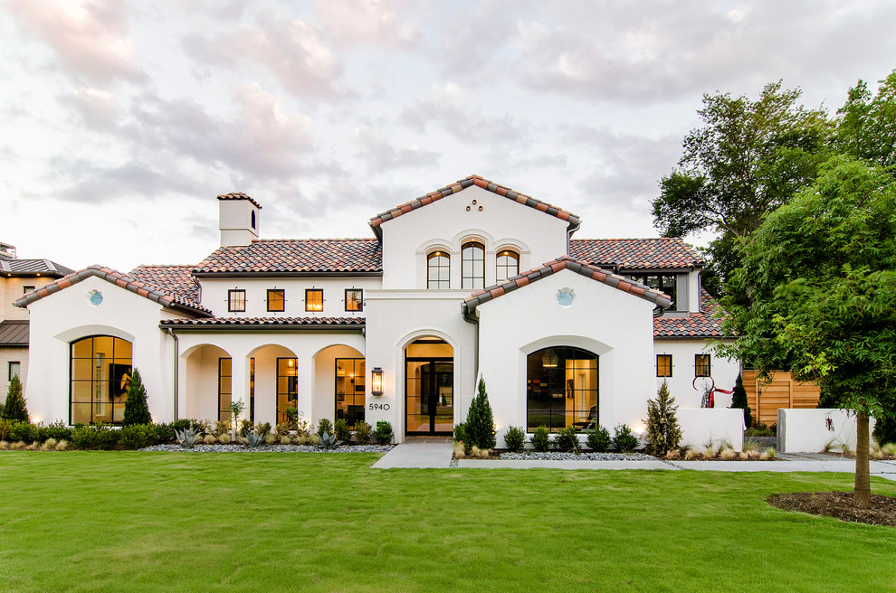 Photo of a mediterranean two-storey stucco white exterior in Dallas with a gable roof.