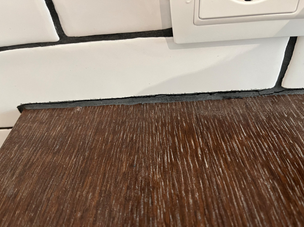 Broken Grout between Tile and Wood