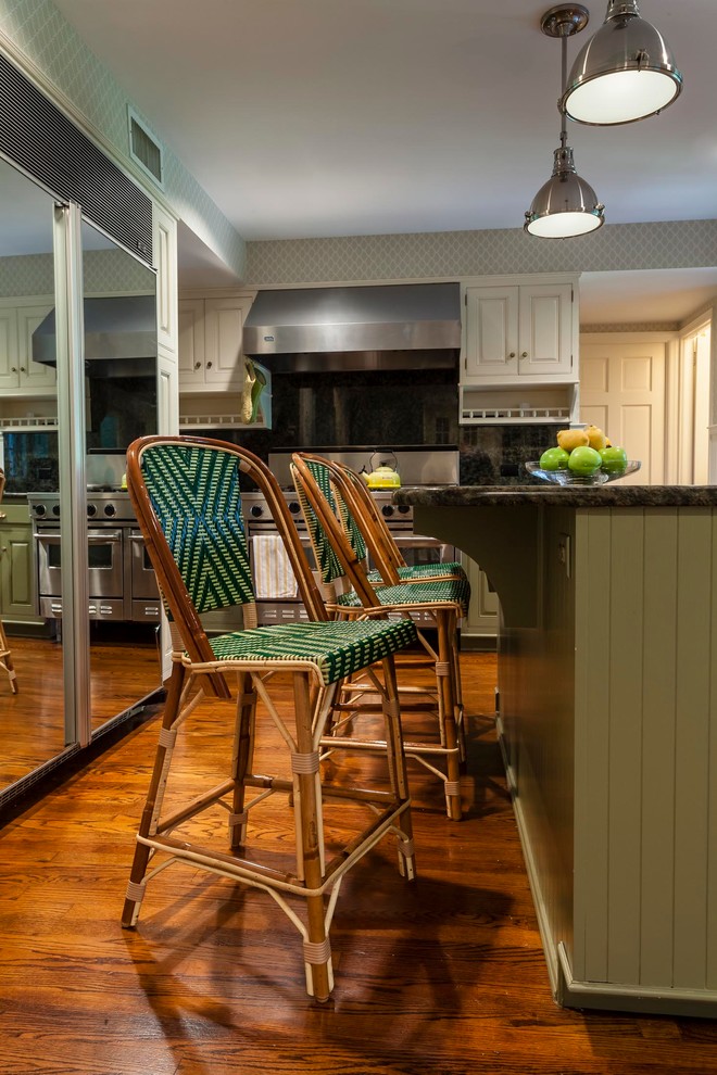 Design ideas for a mid-sized country separate kitchen in New York with beaded inset cabinets, green splashback, stainless steel appliances, with island, beige cabinets, granite benchtops, stone tile splashback and carpet.