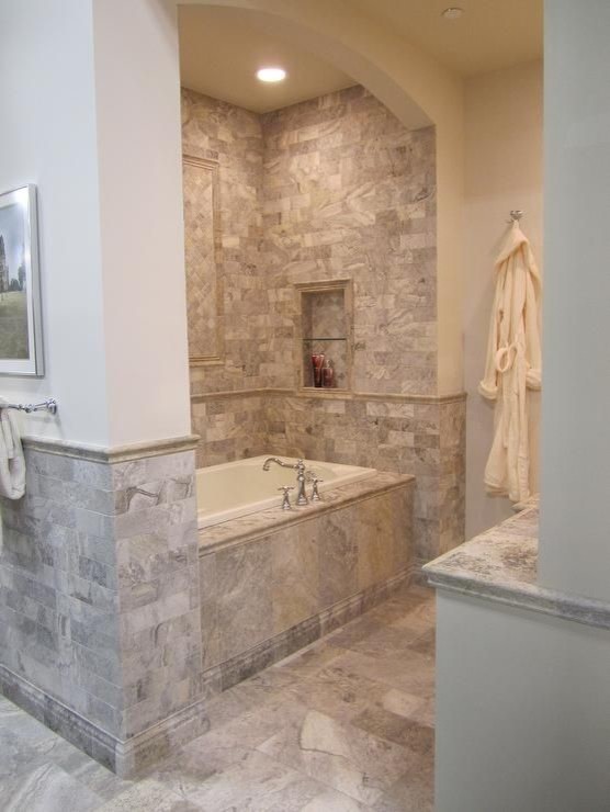 Design ideas for a small mediterranean master bathroom in Cincinnati with shaker cabinets, white cabinets, a drop-in tub, a corner shower, a two-piece toilet, gray tile, stone tile, travertine floors, a drop-in sink, tile benchtops, beige walls and beige floor.