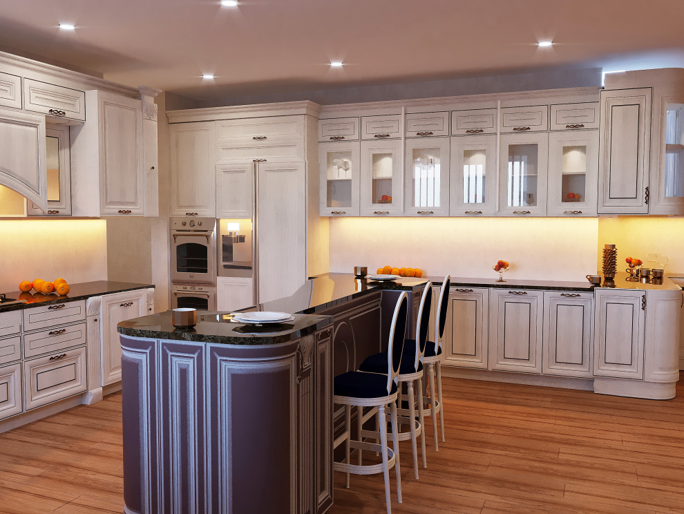 This is an example of a mid-sized traditional u-shaped separate kitchen in DC Metro with a drop-in sink, raised-panel cabinets, beige cabinets, marble benchtops, stainless steel appliances, with island and black benchtop.