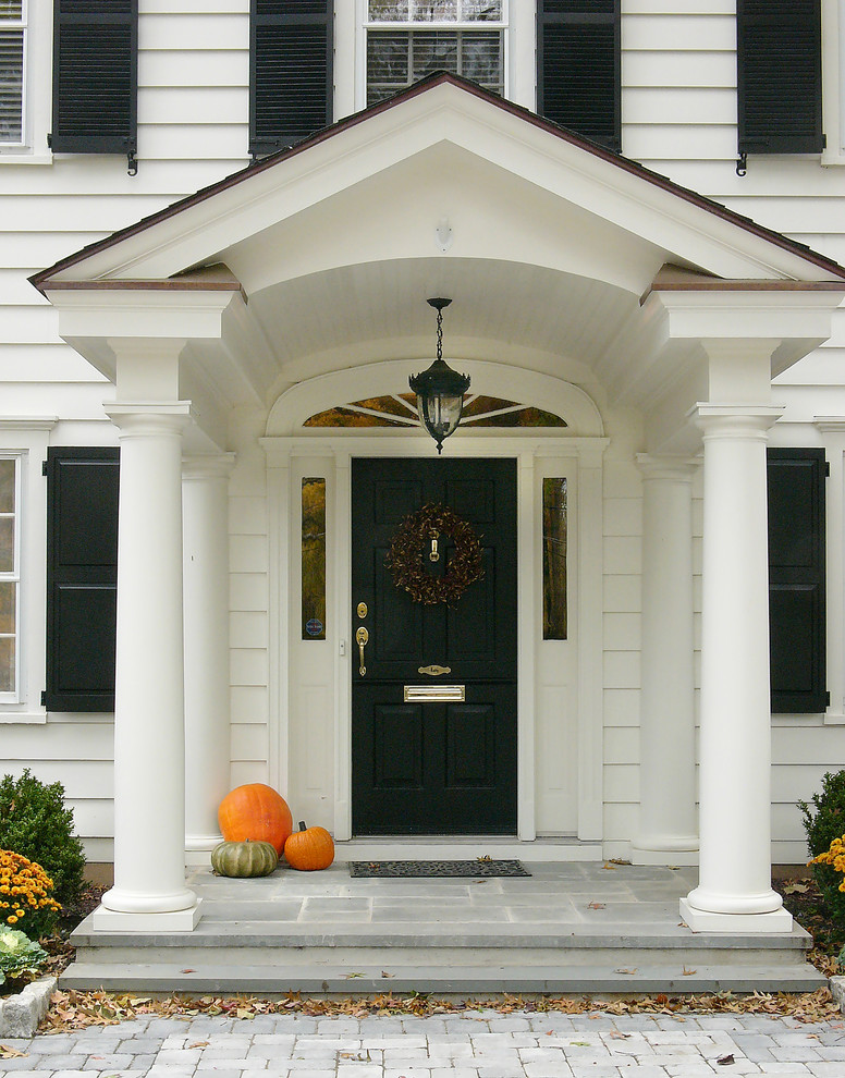 This is an example of a mid-sized traditional front door in Other with white walls, a single front door and a black front door.