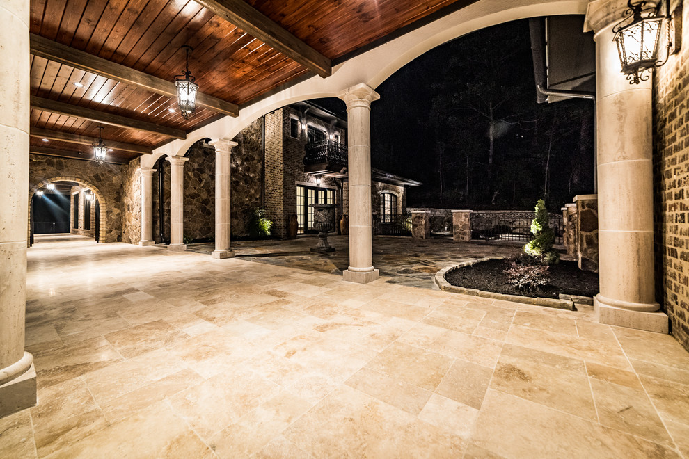 Inspiration for a mid-sized rustic travertine floor and beige floor foyer remodel with brown walls and a glass front door