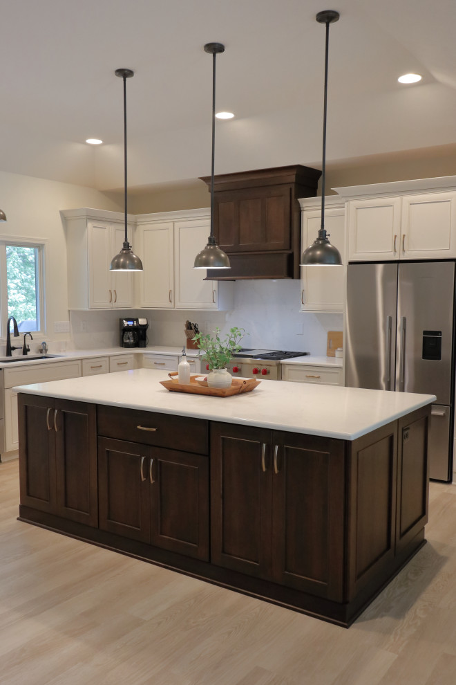 Inspiration for a large transitional l-shaped kitchen remodel with an undermount sink, recessed-panel cabinets, quartz countertops, white backsplash, quartz backsplash, stainless steel appliances and white countertops