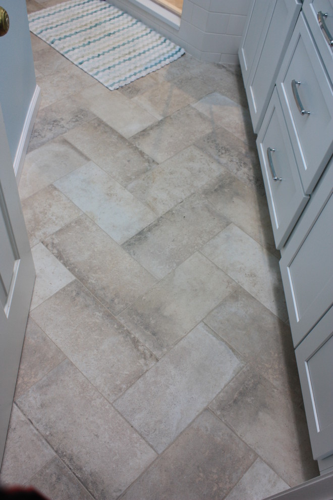 Mid-sized transitional 3/4 beige tile, blue tile and mosaic tile ceramic tile corner shower photo with shaker cabinets, white cabinets, a one-piece toilet, blue walls, an undermount sink and solid surface countertops