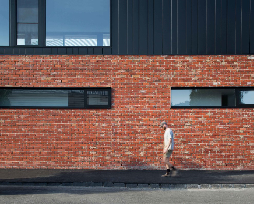 Mid-sized modern two-storey brick black house exterior in Melbourne.
