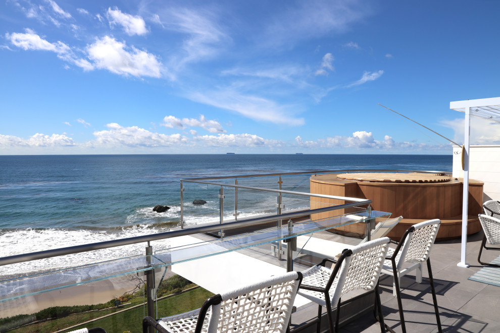 Inspiration for a coastal first floor glass railing terrace in Los Angeles with no cover.