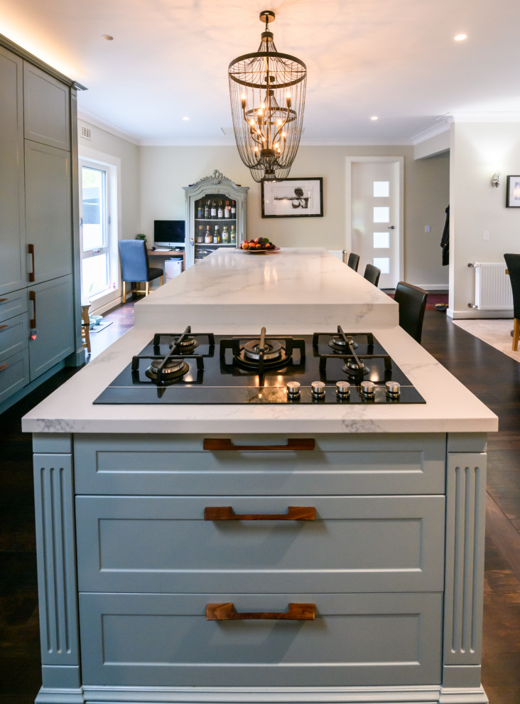 Inspiration for a mid-sized timeless open concept kitchen remodel in Melbourne with a double-bowl sink, shaker cabinets, green cabinets, quartz countertops, white backsplash, two islands and white countertops