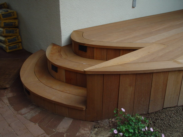 Photo of a mid-sized contemporary wood curved staircase in New York with wood risers.