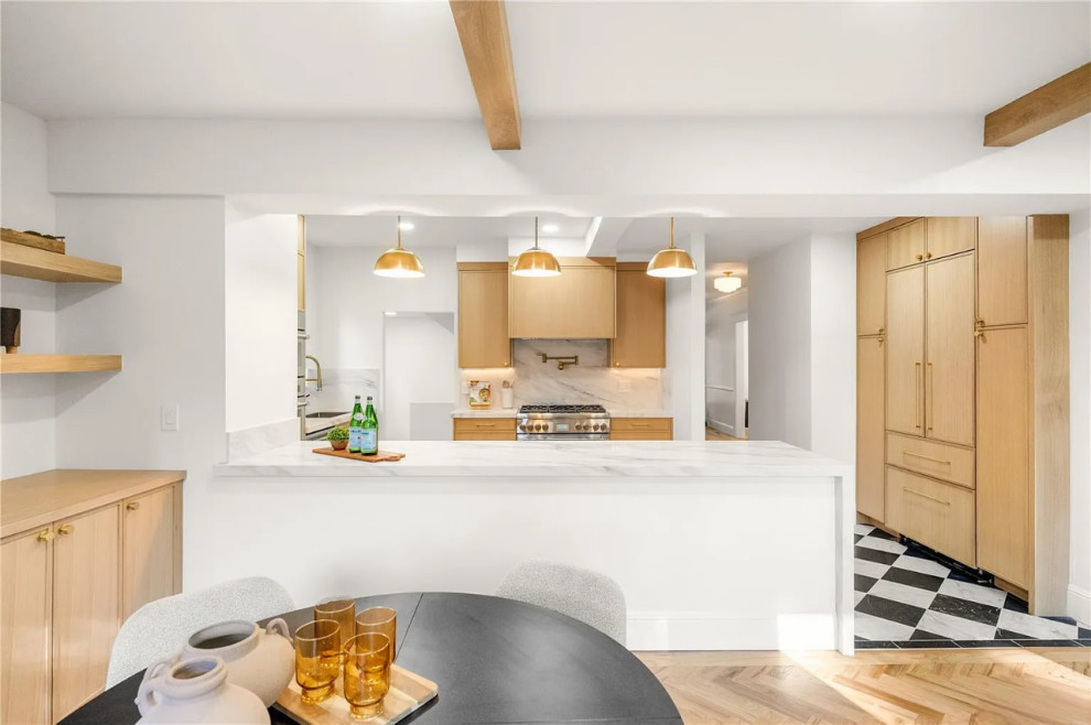 Modern cabinetry, sleek surfaces, and thoughtful details define this renewed kit