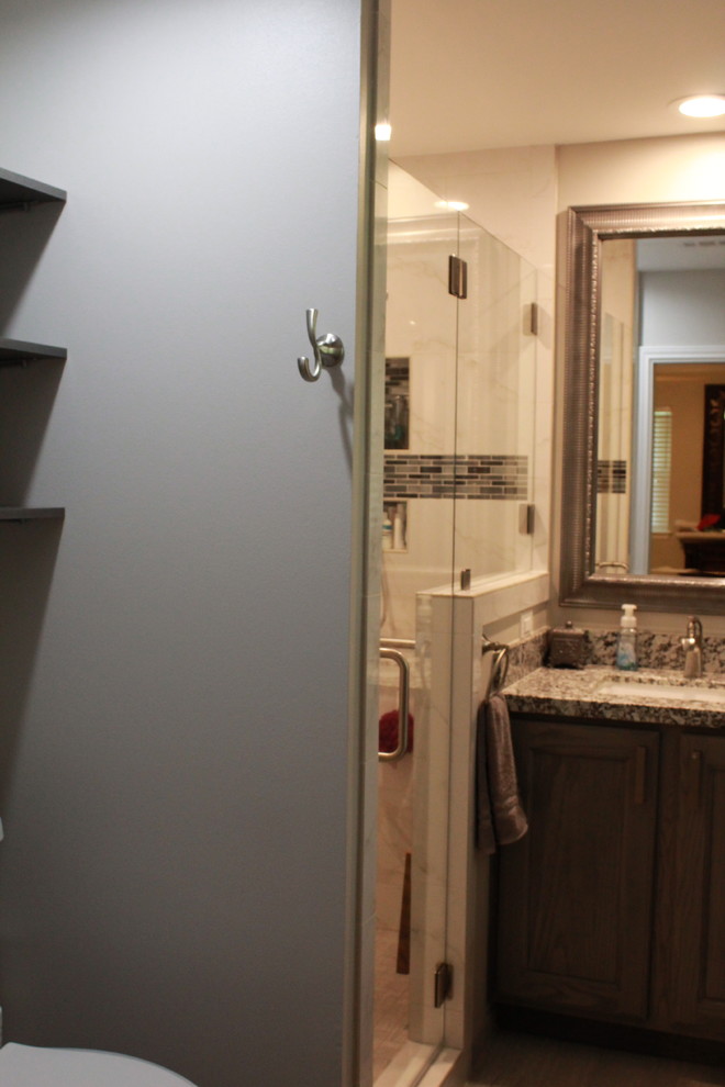 Example of a small transitional master white tile and porcelain tile porcelain tile and gray floor bathroom design in Houston with shaker cabinets, gray cabinets, gray walls, granite countertops and a hinged shower door