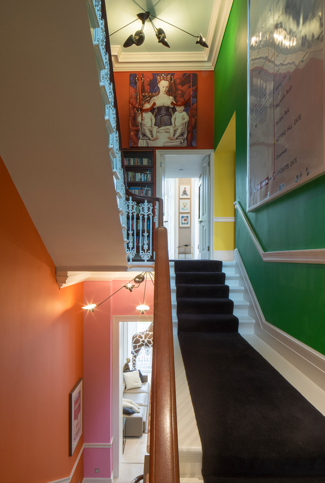 Inspiration for a mid-sized eclectic carpeted u-shaped staircase in London with carpet risers.