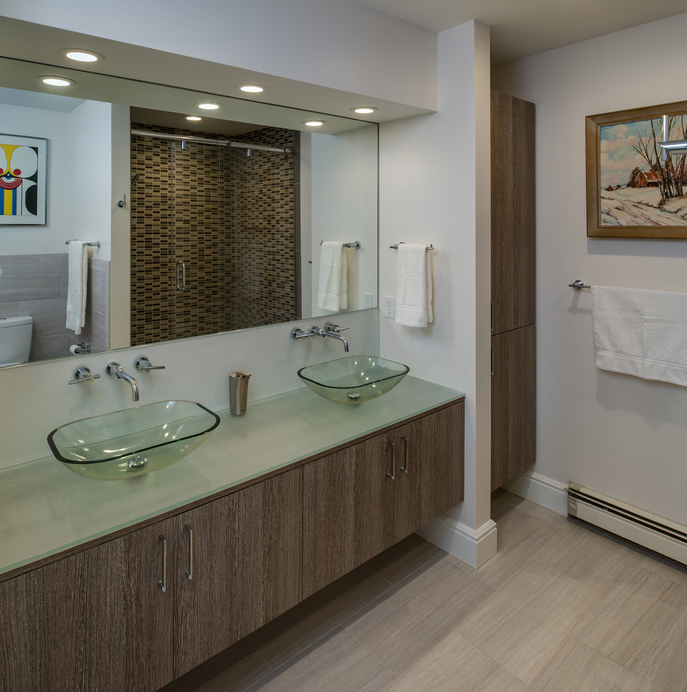 Small traditional kids bathroom in Miami with flat-panel cabinets, grey cabinets, an alcove shower, a two-piece toilet, multi-coloured tile, ceramic tile, white walls, ceramic floors, a vessel sink and glass benchtops.