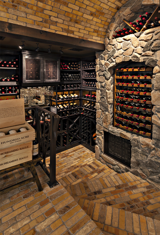 Inspiration for a large mediterranean wine cellar in Phoenix with brick floors, storage racks and multi-coloured floor.