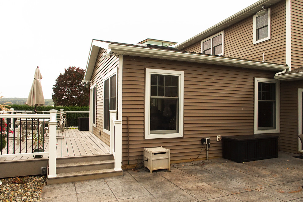 This is an example of a mid-sized transitional two-storey beige exterior in Philadelphia with vinyl siding and a gable roof.