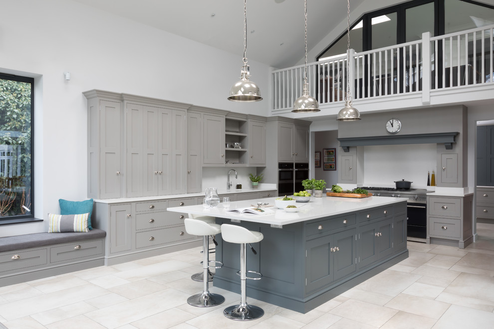 Design ideas for a large traditional u-shaped open plan kitchen in Surrey with an integrated sink, shaker cabinets, grey cabinets, quartzite benchtops, white splashback, stone slab splashback, stainless steel appliances, porcelain floors, with island, multi-coloured floor and white benchtop.