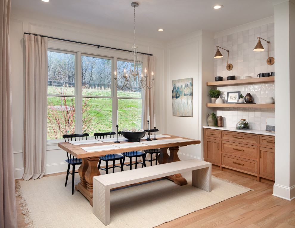 Design ideas for a mid-sized transitional kitchen/dining combo in Atlanta with white walls, light hardwood floors, brown floor and panelled walls.