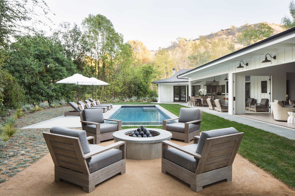 Inspiration for a country backyard rectangular lap pool in Los Angeles with concrete pavers.