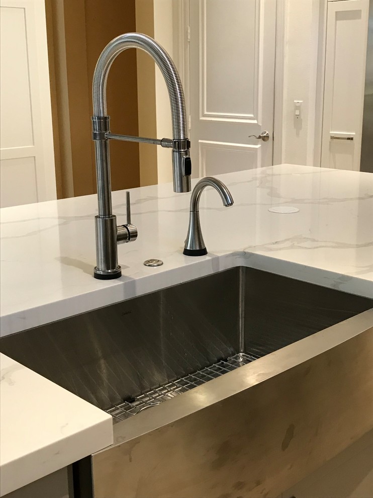 Large transitional kitchen photo in Miami with a farmhouse sink, shaker cabinets, white cabinets, quartz countertops, gray backsplash, glass tile backsplash, stainless steel appliances, an island and multicolored countertops