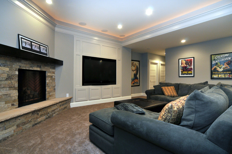 This is an example of a mid-sized traditional fully buried basement in Denver with blue walls, carpet, a standard fireplace and a stone fireplace surround.
