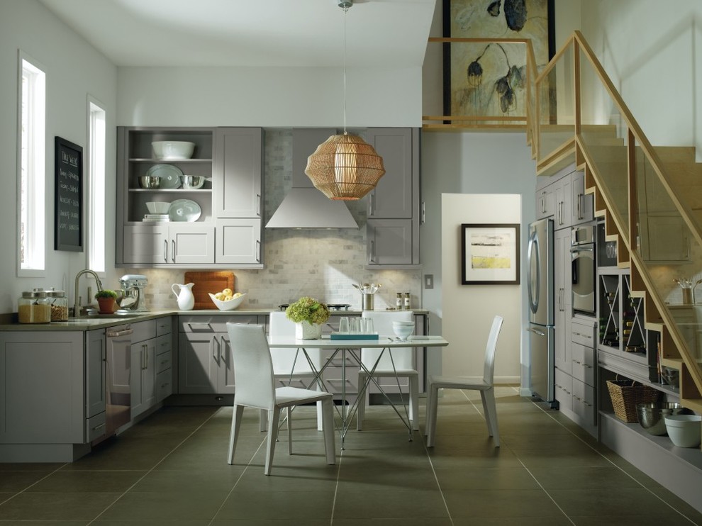 Example of a transitional u-shaped eat-in kitchen design with louvered cabinets, gray cabinets and gray backsplash