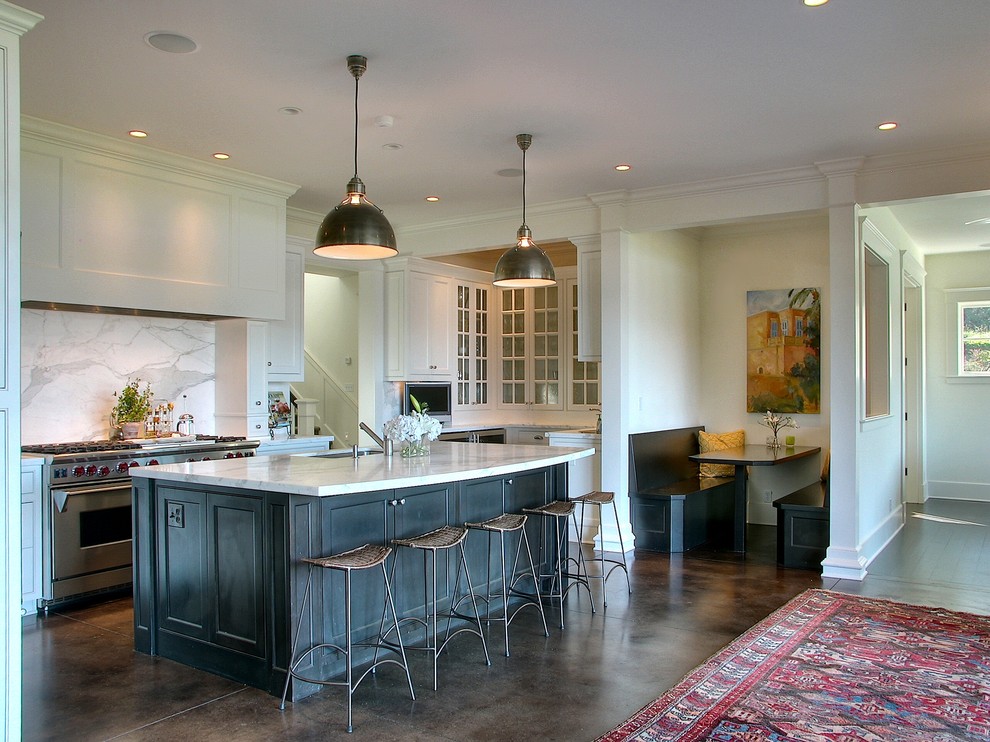 Inspiration for a traditional kitchen in Seattle with glass-front cabinets, stainless steel appliances and brown floor.