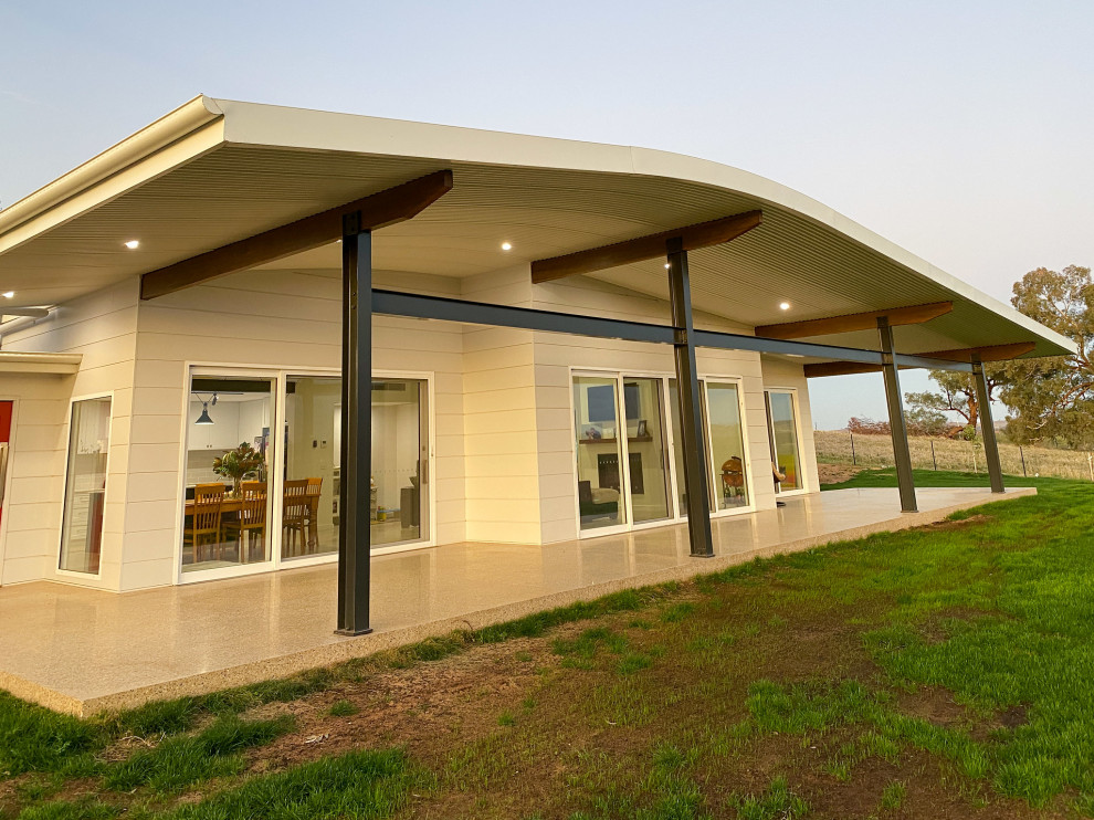 Industrial house exterior with concrete fiberboard siding and a metal roof.