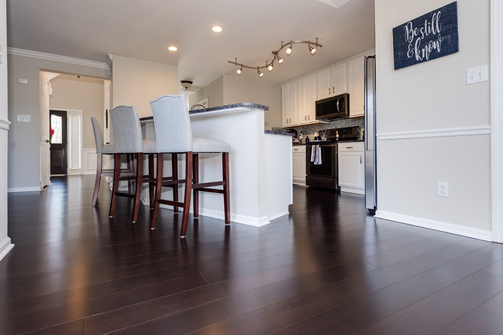 Example of a bamboo floor and brown floor kitchen design in Charlotte