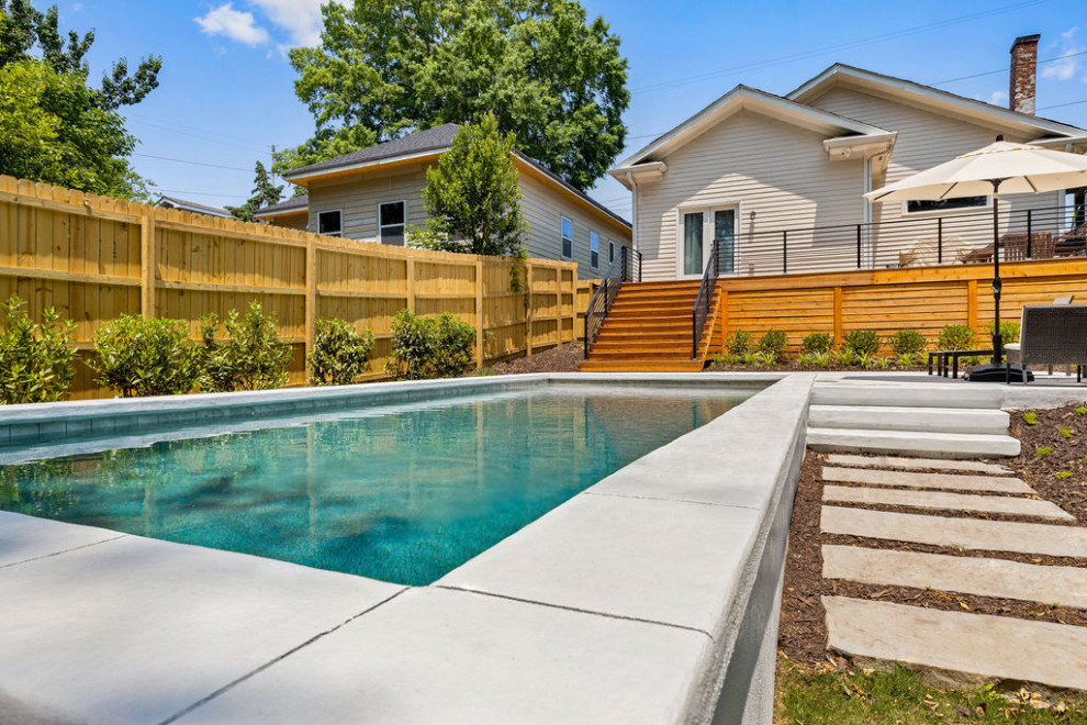 Photo of a mid-sized contemporary backyard rectangular pool in Atlanta with with privacy feature and stamped concrete.