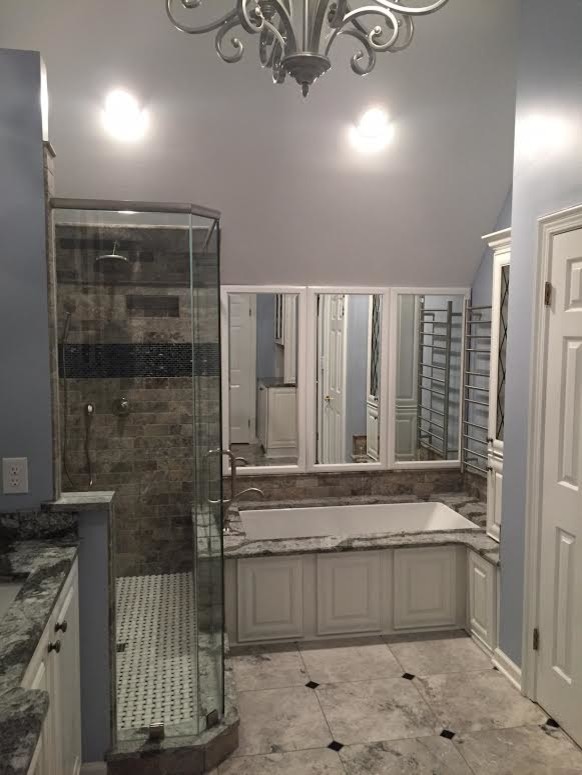 This is an example of a mid-sized traditional master bathroom in Other with an undermount sink, raised-panel cabinets, white cabinets, engineered quartz benchtops, an undermount tub, a corner shower, a two-piece toilet, gray tile, stone tile, blue walls and marble floors.
