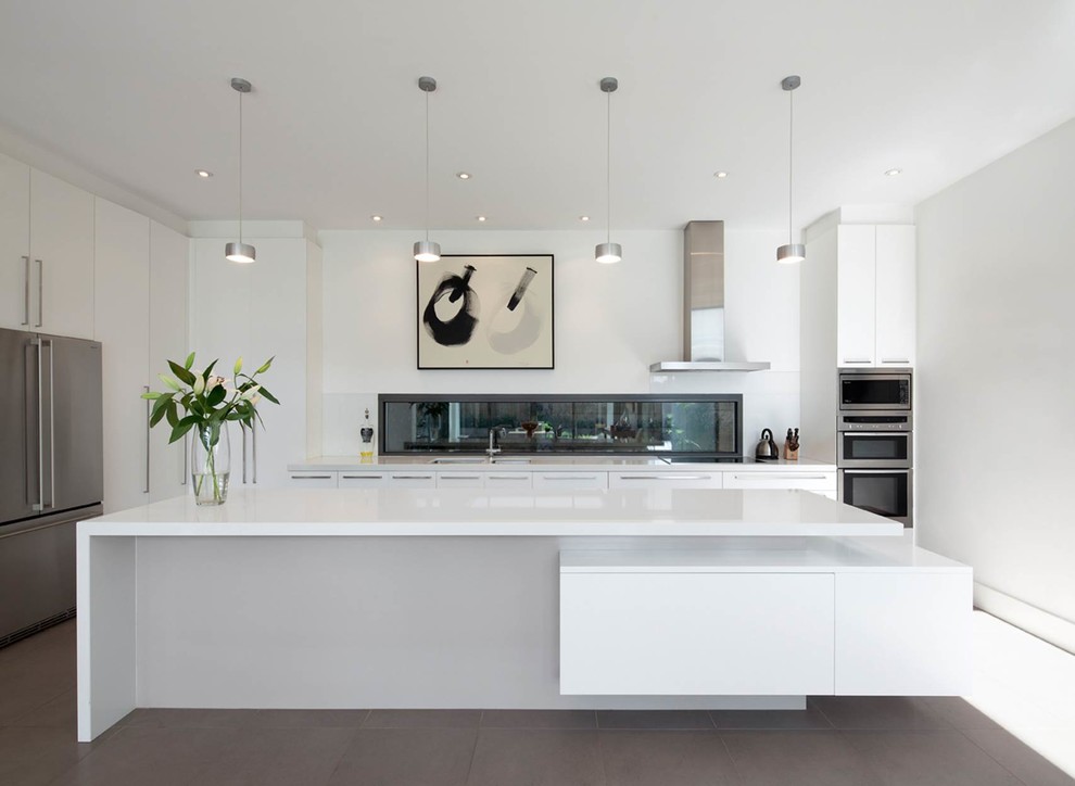 Contemporary galley kitchen in Melbourne with an undermount sink, flat-panel cabinets, white cabinets, ceramic floors and with island.