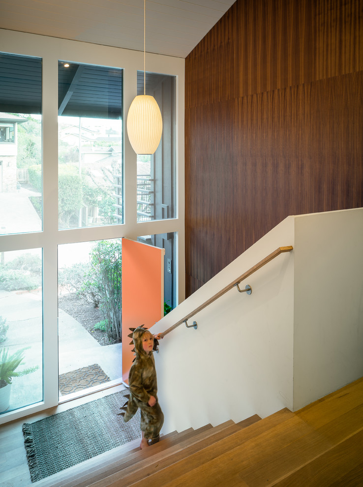 Design ideas for a large midcentury hallway in San Francisco with white walls and light hardwood floors.