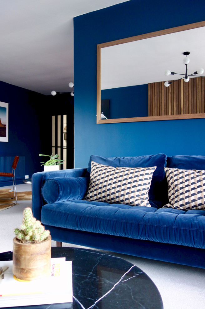 Photo of a large midcentury open concept living room in Other with blue walls, carpet, a wall-mounted tv and grey floor.
