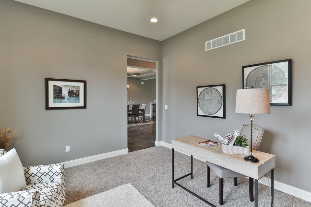 Design ideas for a mid-sized transitional home office in St Louis with grey walls, carpet, no fireplace, a freestanding desk and beige floor.