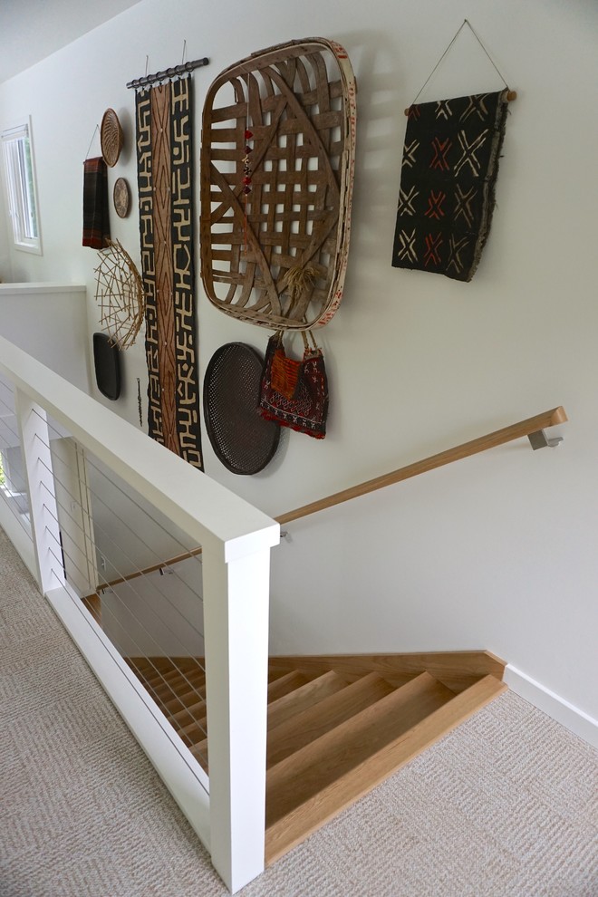 Inspiration for a contemporary wood straight staircase in Kansas City with wood risers.