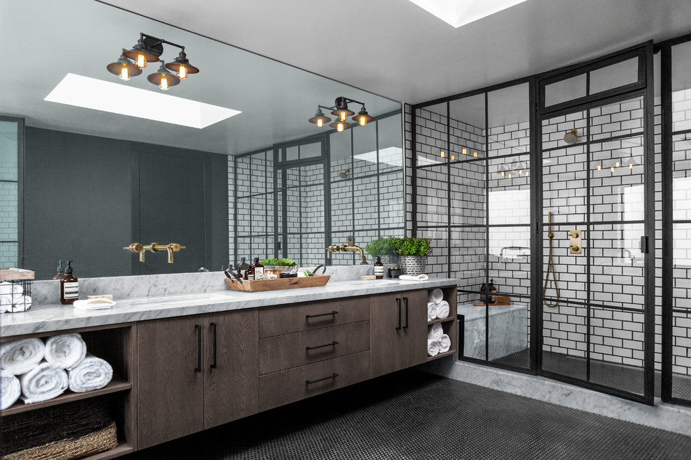 Large industrial master wet room bathroom with porcelain tile, black walls, ceramic floors, marble benchtops, black floor, a hinged shower door, grey benchtops, flat-panel cabinets, dark wood cabinets, white tile and an undermount sink.