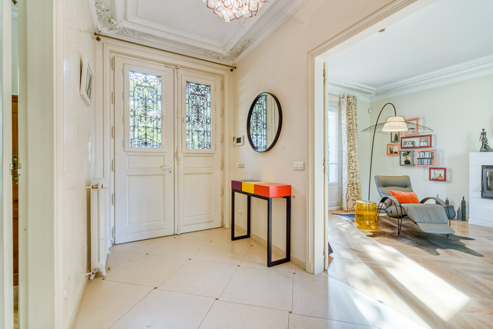 Mid-sized eclectic marble floor, beige floor and tray ceiling entryway photo in Paris with beige walls and a white front door