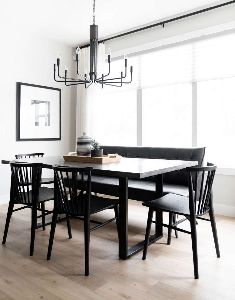 Inspiration for a scandinavian dining room in Calgary with white walls, beige floor and light hardwood floors.