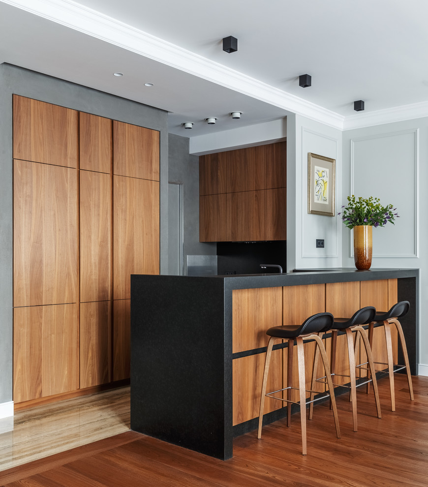 This is an example of a mid-sized contemporary u-shaped open plan kitchen in Moscow with a single-bowl sink, granite benchtops, black splashback, marble splashback, stainless steel appliances, marble floors, with island, beige floor, flat-panel cabinets and medium wood cabinets.
