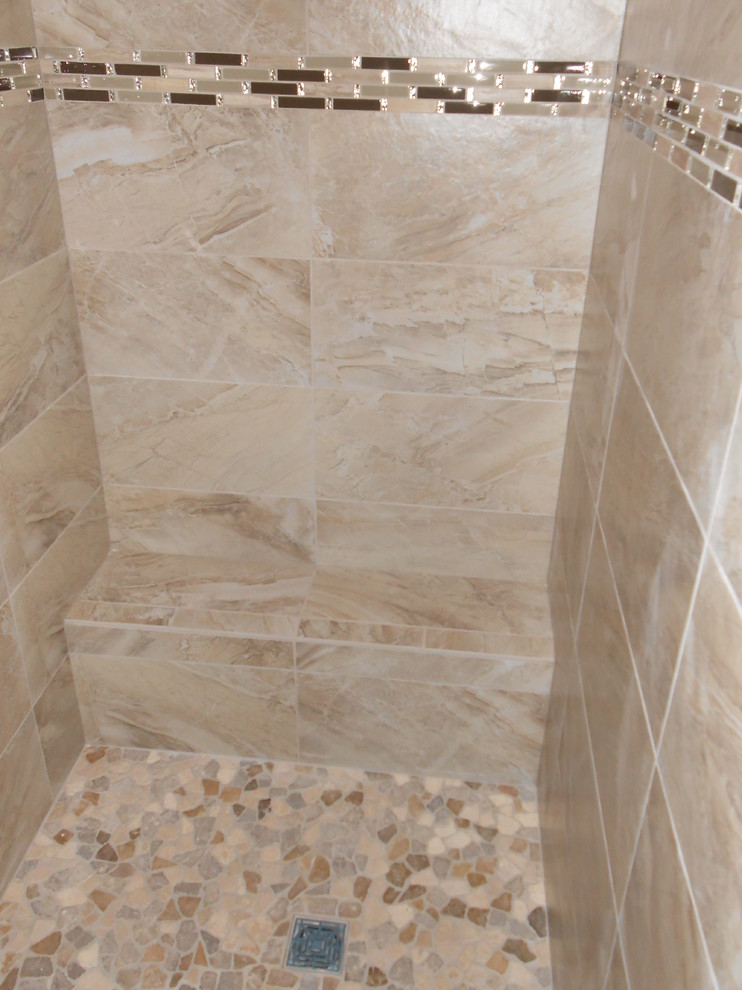 Design ideas for a mid-sized contemporary master bathroom in Omaha with an open shower, porcelain tile, beige walls, beige tile and pebble tile floors.