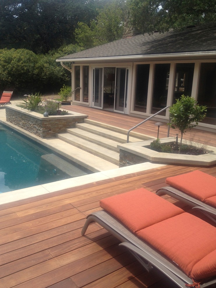 This is an example of a mid-sized contemporary backyard rectangular lap pool in San Francisco with decking.