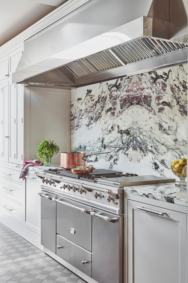 Inspiration for a large traditional single-wall open plan kitchen in Essex with a drop-in sink, shaker cabinets, marble benchtops, white splashback, marble splashback, stainless steel appliances, with island and white benchtop.